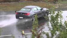 BMW M6 Cran Coupe drifting in the rain from above point of view with zoom